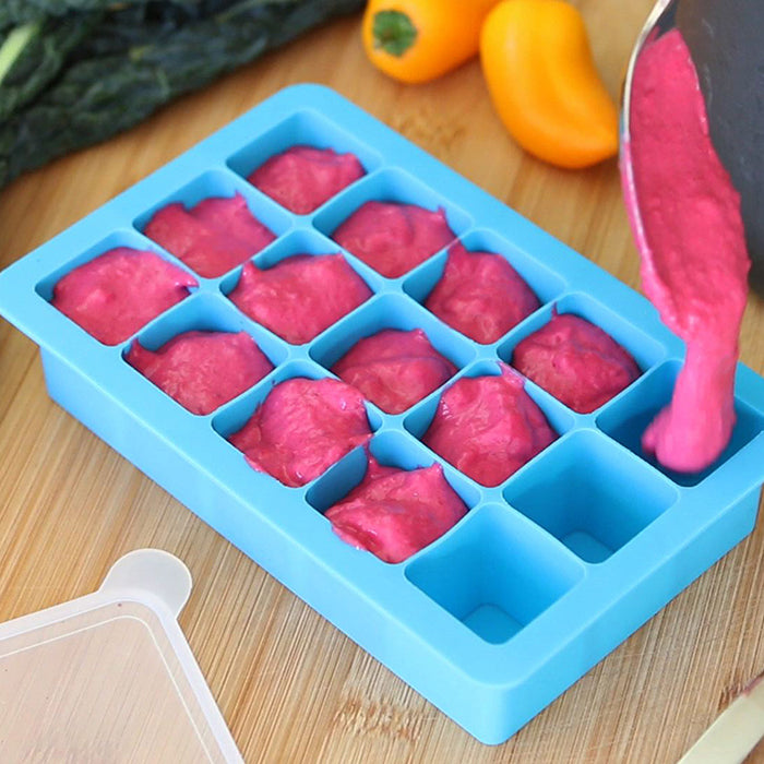 A yummy raspberry puree being poured into the aqua Fresh Baby Food Freezer Tray.