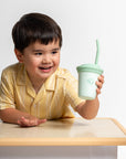 toddler holding green sprouts my first straw cup