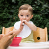 Young toddler eating from the pink Learning Spoon Set