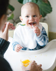 A mother feeding her baby with the Learning Spoon Set