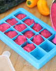 A yummy raspberry puree being poured into the aqua Fresh Baby Food Freezer Tray.