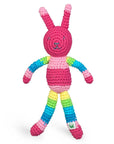 A pink and striped rainbow patterned rattle crocheted to look like a rabbit.