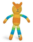 An orange and striped rainbow patterned rattle crocheted to look like a fox.