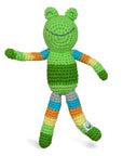 A green and striped rainbow patterned rattle crocheted to look like a frog.