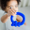 A little boy holding up to show off the blue blueberry Fruit Teether made from Silicone