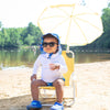 A young toddler looking like he was chilling in a beach chair with an umbrella while wearing black Flexible Sunglasses.